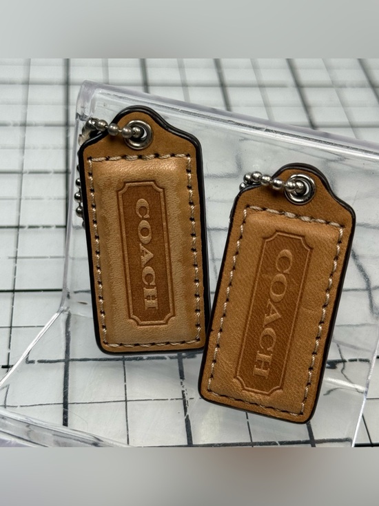 Coach Other - Coach two small Tan Leather Hang Tag Keychain Set. 2 by 1 inches. One with wear